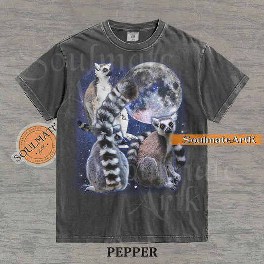 Collage of ring-tailed lemurs in various poses in front of a glowing full moon and a starry nebula on a washed pepper shirt.