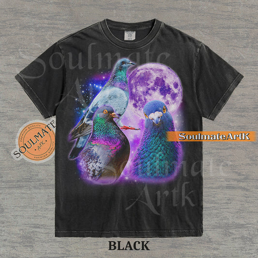 Collage of three pigeons with iridescent feathers in front of a glowing purple moon and a starry nebula on a washed black shirt.