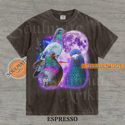 Collage of three pigeons with iridescent feathers in front of a glowing purple moon and a starry nebula on a washed espresso shirt.