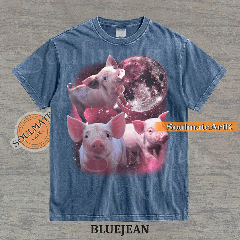 Collage of three pink piglets in front of a glowing pink moon and a starry nebula on a washed bluejean shirt.