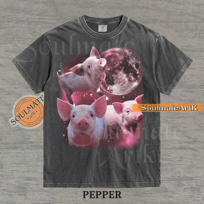 Collage of three pink piglets in front of a glowing pink moon and a starry nebula on a washed pepper shirt.
