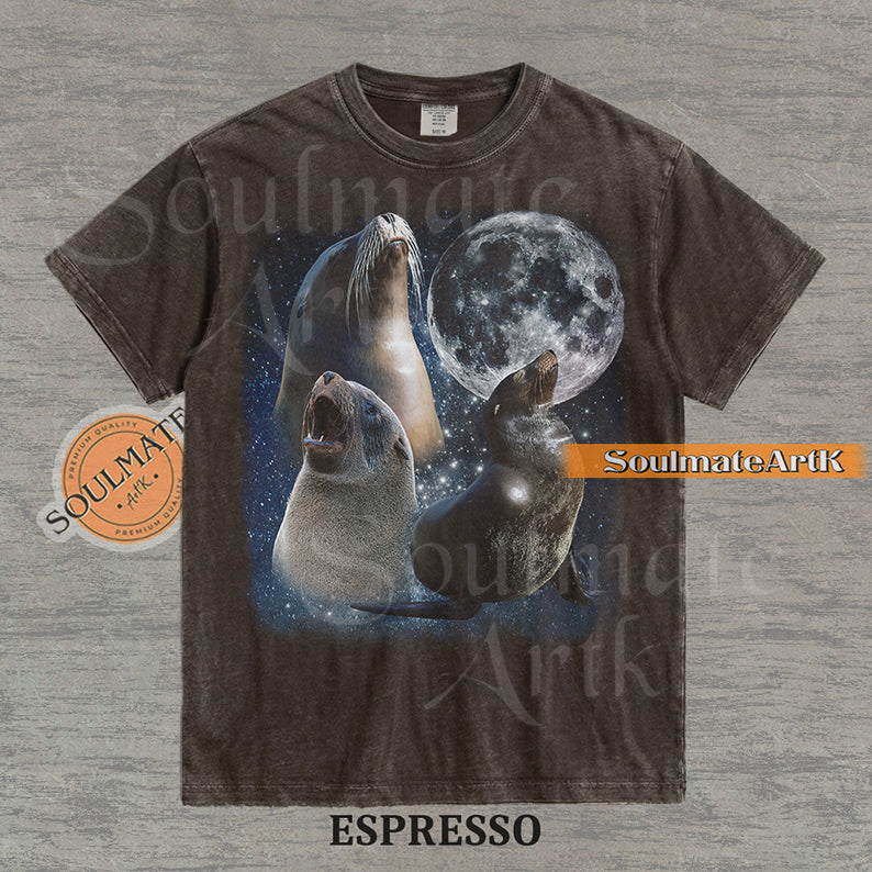 Collage of three sea lions in front of a glowing full moon and a starry night sky on a washed espresso shirt.