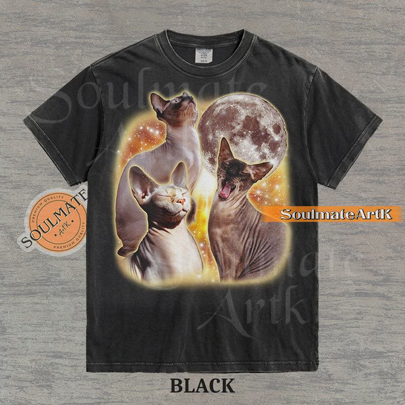 Collage of three Sphynx cats in front of a glowing moon and a golden starry nebula on a washed black shirt.
