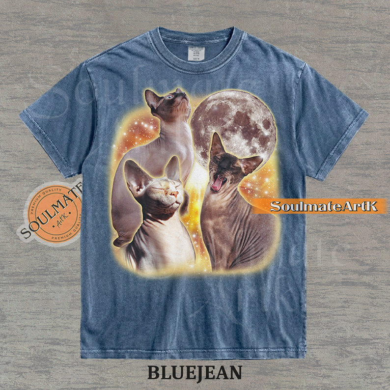 Collage of three Sphynx cats in front of a glowing moon and a golden starry nebula on a washed bluejean shirt.