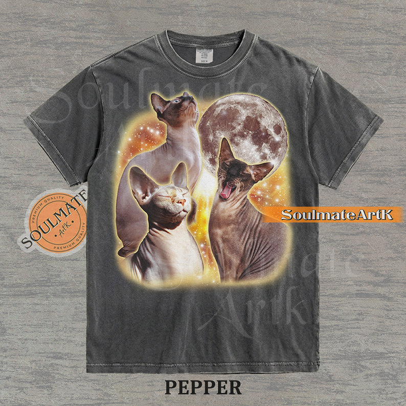 Collage of three Sphynx cats in front of a glowing moon and a golden starry nebula on a washed pepper shirt.