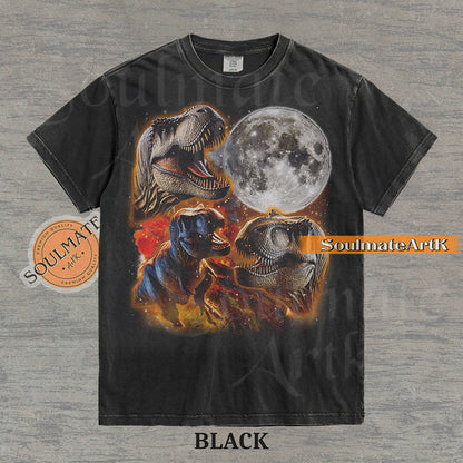 Graphic collage of three T-Rexes next to a large full moon in a starry, colorful space setting on a washed black t-shirt.
