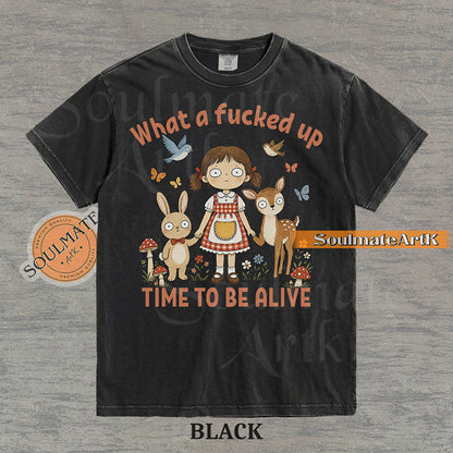 Illustration of a startled girl with a bunny and deer in a forest with the text "What a fucked up TIME TO BE ALIVE" on a washed black t-shirt.