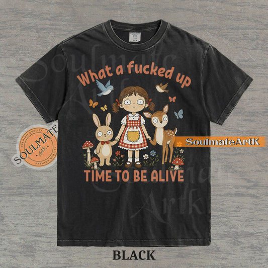 Illustration of a startled girl with a bunny and deer in a forest with the text "What a fucked up TIME TO BE ALIVE" on a washed black t-shirt.