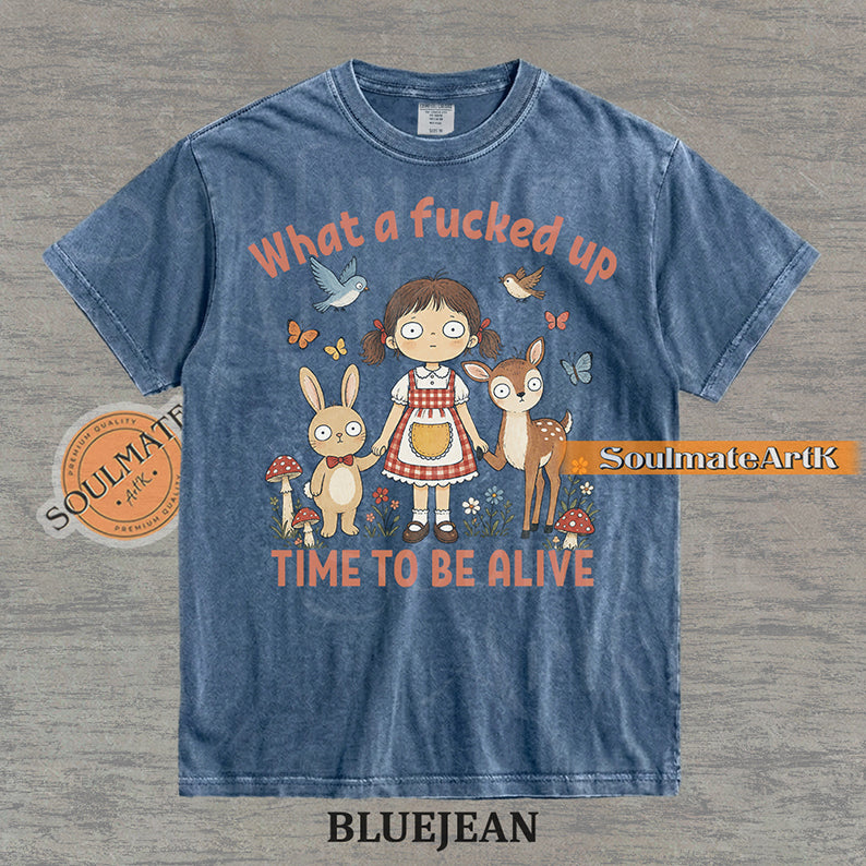 Illustration of a startled girl with a bunny and deer in a forest with the text "What a fucked up TIME TO BE ALIVE" on a washed bluejean t-shirt.