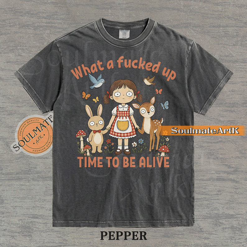 Illustration of a startled girl with a bunny and deer in a forest with the text "What a fucked up TIME TO BE ALIVE" on a washed pepper t-shirt.