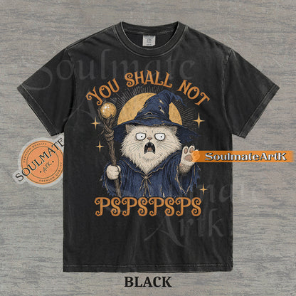 Vintage-style illustration of a white cat dressed as a wizard with a staff and hat, featuring the text You Shall Not PSPSPSPS on a washed Comfort Colors t-shirt.