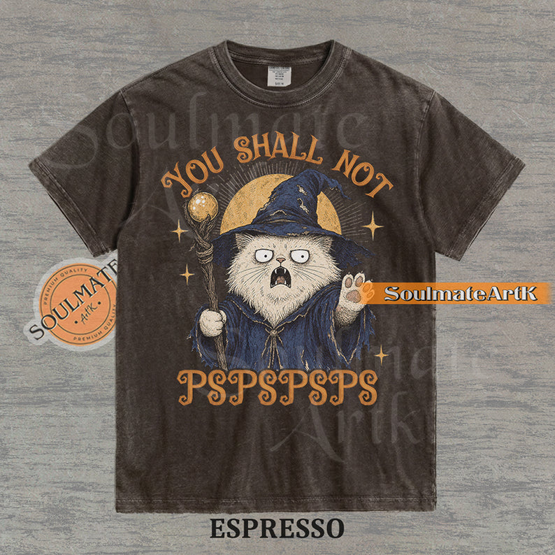 Vintage-style illustration of a white cat dressed as a wizard with a staff and hat, featuring the text You Shall Not PSPSPSPS on a washed Espresso Comfort Colors t-shirt.