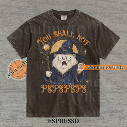 Vintage-style illustration of a white cat dressed as a wizard with a staff and hat, featuring the text You Shall Not PSPSPSPS on a washed Espresso Comfort Colors t-shirt.
